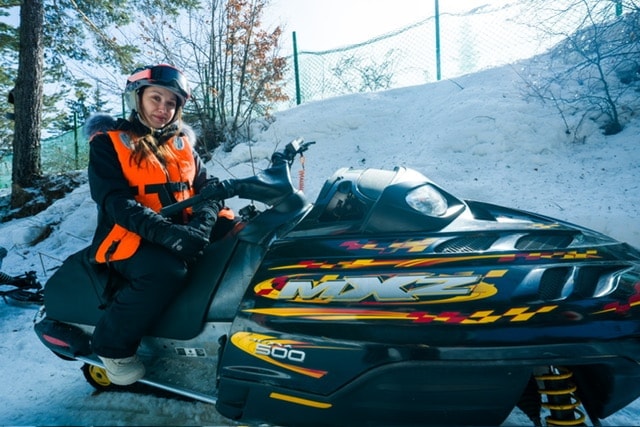 Snowmobile by mountain hut